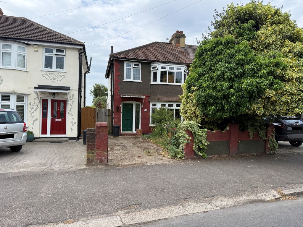 Lot: 90 - SEMI-DETACHED HOUSE FOR IMPROVEMENT - Distant front shot showing front garden and driveway